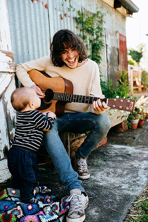 dad singing - Father entertaining son with guitar Stock Photo - Premium Royalty-Free, Code: 614-09211363