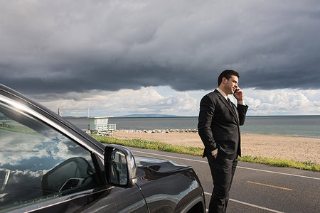 simsearch:614-08877313,k - Businessman talking on smartphone at coastal parking lot Stock Photo - Premium Royalty-Free, Code: 614-09211823