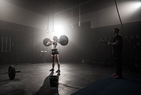 simsearch:614-08877527,k - Young woman lifting barbell, while trainer looks on Stock Photo - Premium Royalty-Free, Code: 614-09211935