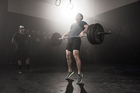 simsearch:614-08877527,k - Young man lifting barbell while trainer looks on Stock Photo - Premium Royalty-Free, Code: 614-09211945