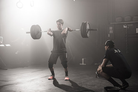simsearch:614-08877527,k - Young man lifting barbell while trainer looks on Stock Photo - Premium Royalty-Free, Code: 614-09211943