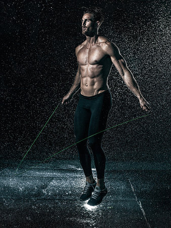 rainy night and single man pic - MId adult man, outdoors, skipping in rain Stock Photo - Premium Royalty-Free, Code: 614-09211987