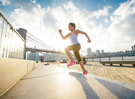 simsearch:614-08874128,k - Female runner running up stairs on riverside, New York, USA Fotografie stock - Premium Royalty-Free, Codice: 614-09212102