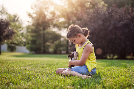 simsearch:614-09212260,k - Girl sitting on grass holding Boston Terrier puppy Stock Photo - Premium Royalty-Free, Code: 614-09212158