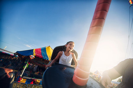 Young girl enjoying fairground ride Stock Photo - Premium Royalty-Free, Code: 614-09212175