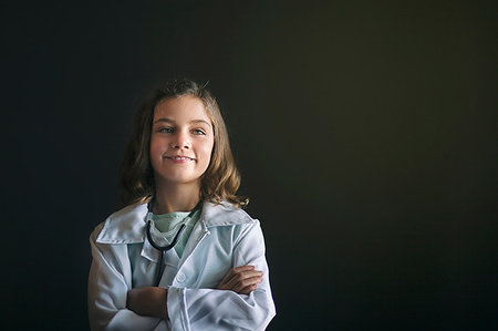 simsearch:614-09212260,k - Portrait of girl dressed up as doctor wearing stethoscope, arms crossed looking away smiling Stock Photo - Premium Royalty-Free, Code: 614-09212258