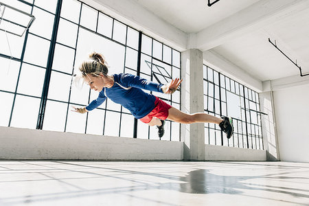 simsearch:614-08879114,k - Low angle view of young woman in gym doing mid air push up Stock Photo - Premium Royalty-Free, Code: 614-09212261