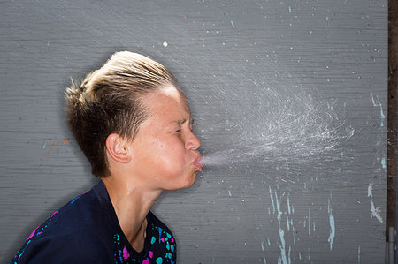 spitting - Side view of teenage boy, eyes closed, spitting out water Stock Photo - Premium Royalty-Free, Code: 614-09212291