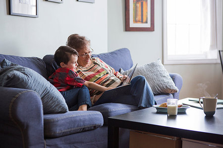 simsearch:614-08535822,k - Senior woman reading book with grandson on sofa Stock Photo - Premium Royalty-Free, Code: 614-09212318