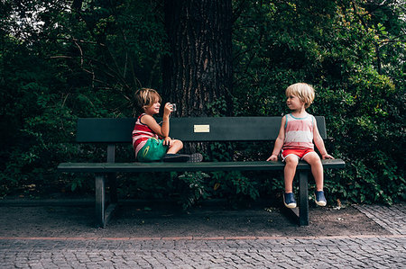 Boys on park bench using digital camera to take photograph Stock Photo - Premium Royalty-Free, Code: 614-09212395