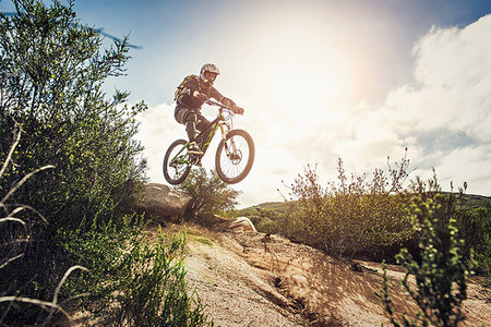 Downhill mountain biker jumping Stock Photo - Premium Royalty-Free, Code: 614-09212509