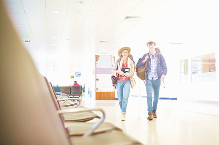 simsearch:614-06402755,k - Young couple at airport carrying backpacks, low angle view Stock Photo - Premium Royalty-Free, Code: 614-09213725