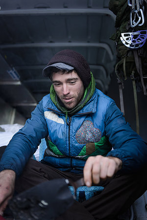 road trip british columbia - Young male rock climber preparing climbing equipment in camper van Stock Photo - Premium Royalty-Free, Code: 614-09213859