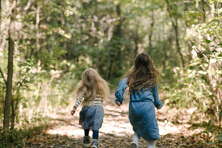 short skirt for kids - Sisters running in forest Stock Photo - Premium Royalty-Free, Code: 614-09231966