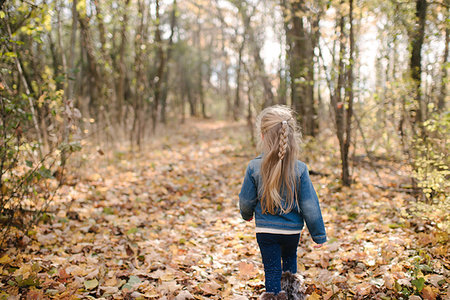 Little girl exploring forest Stock Photo - Premium Royalty-Free, Code: 614-09231982