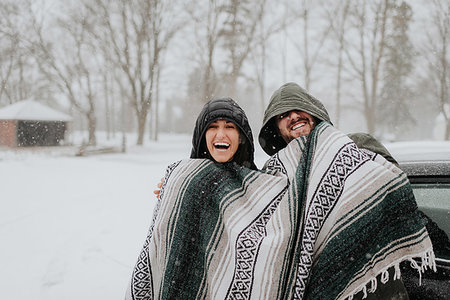 Couple wrapped in blanket in snowy landscape, Georgetown, Canada Stock Photo - Premium Royalty-Free, Code: 614-09232003