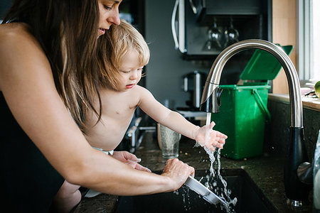 Mother and son washing plate in kitchen sink Stock Photo - Premium Royalty-Free, Code: 614-09232065