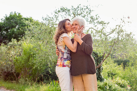 simsearch:614-09245254,k - Mature woman kissing mother on cheek in garden Stock Photo - Premium Royalty-Free, Code: 614-09245255