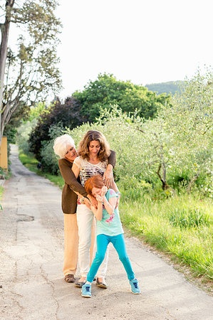 simsearch:6113-06721198,k - Girl on rural road with mother and grandmother Stock Photo - Premium Royalty-Free, Code: 614-09245250