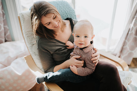 simsearch:614-09258603,k - Baby boy sitting on mother's lap in living room, portrait Foto de stock - Sin royalties Premium, Código: 614-09249651