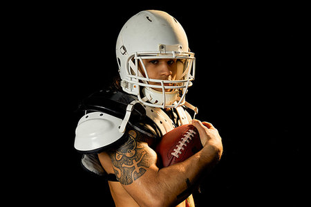 simsearch:614-00893424,k - Portrait of football player, black background Stock Photo - Premium Royalty-Free, Code: 614-09249755