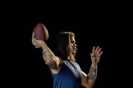 simsearch:6109-08389992,k - Portrait of football player with football, black background Stock Photo - Premium Royalty-Free, Code: 614-09249787