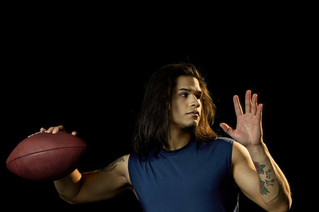 simsearch:6109-08389992,k - Portrait of football player with football, black background Stock Photo - Premium Royalty-Free, Code: 614-09249788