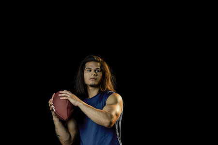 simsearch:6109-08389992,k - Portrait of football player with football, black background Stock Photo - Premium Royalty-Free, Code: 614-09249791