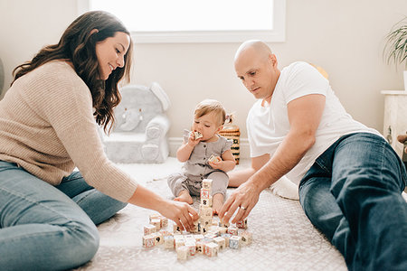 simsearch:614-09253659,k - Mother and father on nursery floor with baby daughter playing with building blocks Stock Photo - Premium Royalty-Free, Code: 614-09258618