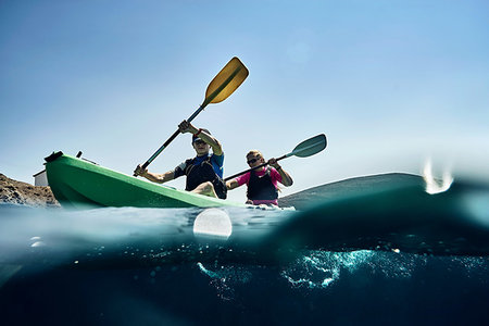 simsearch:614-06897031,k - Teenage boy and mother sea kayaking on ocean, surface level view, Limnos, Khios, Greece Stock Photo - Premium Royalty-Free, Code: 614-09258734