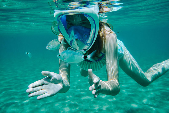 Underwater view of girl snorkelling, looking at fish, Limnos, Khios, Greece Stock Photo - Premium Royalty-Free, Image code: 614-09258742