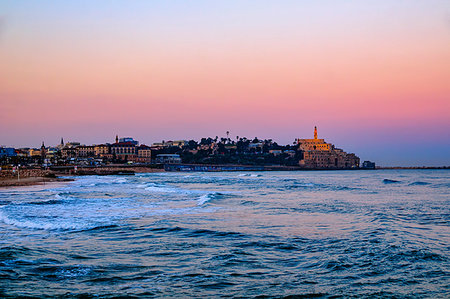 Seascape with distant view of old port skyline and Church of St Peter at dawn, Jaffa, Tel Aviv, Israel Photographie de stock - Premium Libres de Droits, Code: 614-09258905