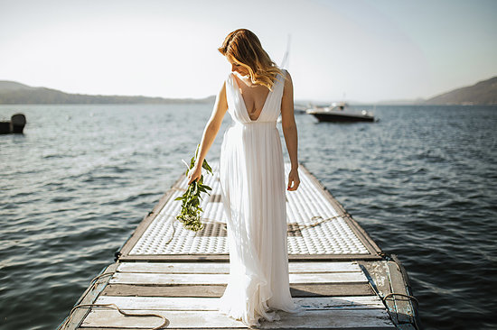 Young bride in wedding dress standing on lake pier, Stresa, Piemonte, Italy Stock Photo - Premium Royalty-Free, Image code: 614-09258915