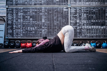 simsearch:614-09259010,k - Young woman stretching upper body in gym Stock Photo - Premium Royalty-Free, Code: 614-09258963