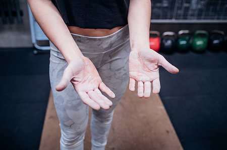 simsearch:614-09259010,k - Young woman showing calluses on palms in gym Photographie de stock - Premium Libres de Droits, Code: 614-09259014