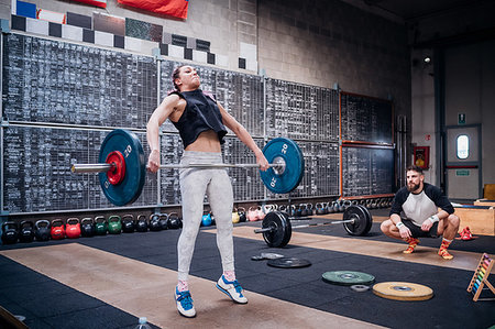 simsearch:614-09259010,k - Young man watching woman lift barbell in gym Stock Photo - Premium Royalty-Free, Code: 614-09259016