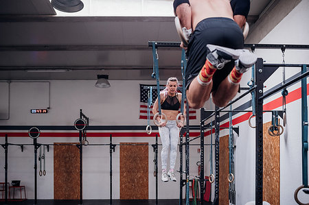 simsearch:649-07596113,k - Young couple balancing on gymnastic rings in gym Photographie de stock - Premium Libres de Droits, Code: 614-09259047