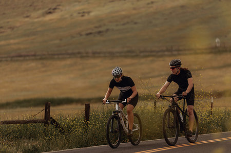 simsearch:614-09159712,k - Young cycling couple cycling on rural road, Exeter, California, USA Photographie de stock - Premium Libres de Droits, Code: 614-09259117