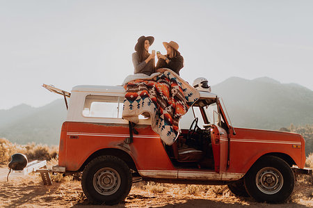 road trip roof - Friends toasting on rooftop of off road vehicle, Kennedy Meadows, California, US Stock Photo - Premium Royalty-Free, Code: 614-09259132