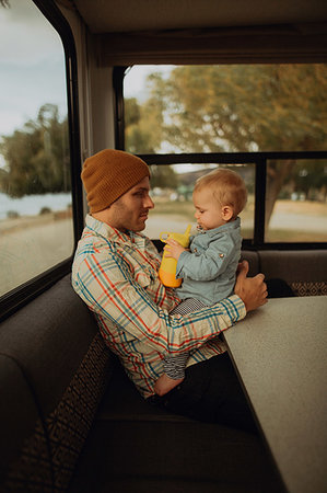 Father and baby relaxing in motorhome, Wanaka, Taranaki, New Zealand Stock Photo - Premium Royalty-Free, Code: 614-09259193