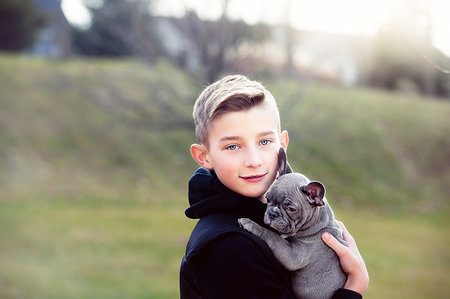 simsearch:614-08982763,k - Boy carrying puppy outdoors Stock Photo - Premium Royalty-Free, Code: 614-09253610