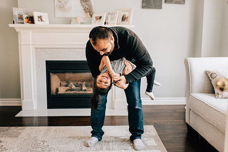 simsearch:614-09253659,k - Girl's father playing with her in living room Stock Photo - Premium Royalty-Free, Code: 614-09253630