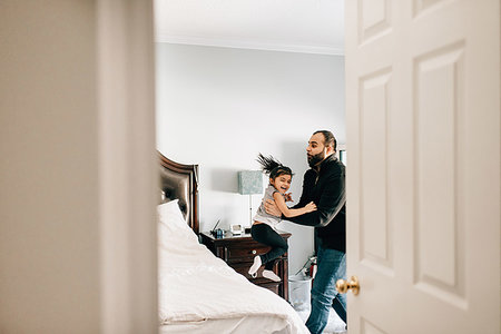 excited happy family and jumping and home - Girl jumping from bed into father's arms Stock Photo - Premium Royalty-Free, Code: 614-09253654