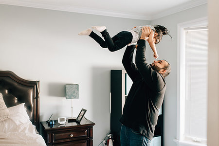 simsearch:614-09253659,k - Girl being held up by father in bedroom Stock Photo - Premium Royalty-Free, Code: 614-09253656