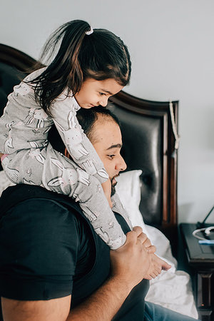 simsearch:614-09253659,k - Girl getting shoulder carry from father in bedroom Stock Photo - Premium Royalty-Free, Code: 614-09253706