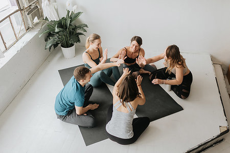 simsearch:614-09276458,k - Friends making high five in yoga studio Foto de stock - Royalty Free Premium, Número: 614-09276263