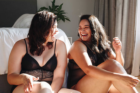 fat women seducing adults - Friends in lingerie laughing in bedroom Stock Photo - Premium Royalty-Free, Code: 614-09276585