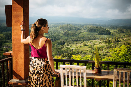 simsearch:614-07031783,k - Young female tourist looking out at landscape from hotel balcony, Bali, Indonesia Stock Photo - Premium Royalty-Free, Code: 614-09276802