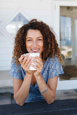 simsearch:614-09276458,k - Woman enjoying hot drink clasped in hands at home Foto de stock - Royalty Free Premium, Número: 614-09276904