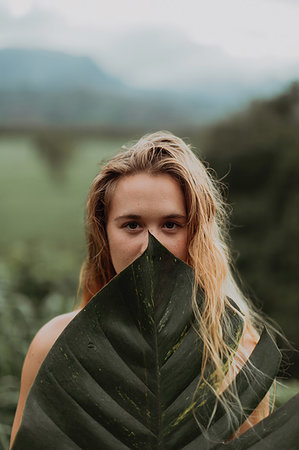 seduction in forest - Woman in bikini holding large leaf, Princeville, Hawaii, US Stock Photo - Premium Royalty-Free, Code: 614-09270233